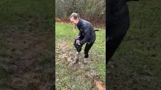 girl getting muddy wellies on the farm