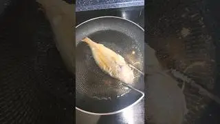 Korean mother-in-law frying Korean gulbi fish in oil. #korea