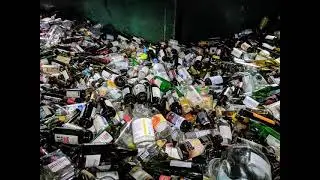 The sound of glass bottles being dropped into a recycling truck