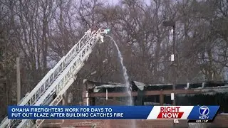 Firefighters working to extinguish hot spots at warehouse fire in south Omaha