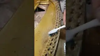 Meticulously cleaning the harp of a Chickering grand manufactured in the