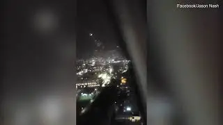 Terrifying moment crane operator is stuck in a crane during tornado