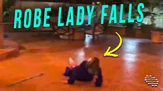 Woman Wearing a Robe Falls While Roller Skating