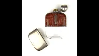 A George V silver and leather mounted glass hip flask