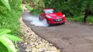A woman driving on a steep uphill road