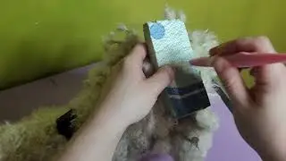 Using a felting needle to create cords on a standard poodle