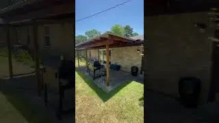 Simple and clean wood frame patio cover with a metal roof stained in a natural cedar color, another