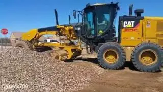 CAT 12M2 Blade Spreading Track-out Rock