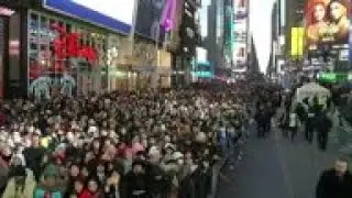 Tourists visit Times Square on NYE for bucket list experience