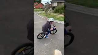 Boy on bike V fence