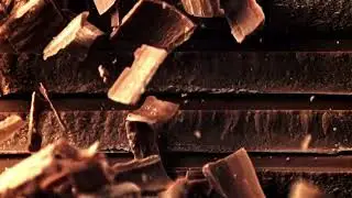 Super Slow Motion Fall of Grated Milk Chocolate on a Pyramid of Chocolate Slices