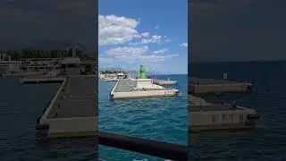 entering the port harbor of the city split croatia on jadrolinija ferry green lighthouse marker pier