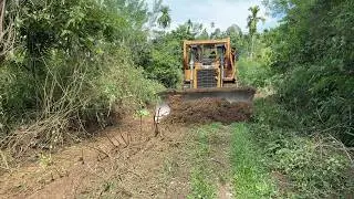 Facing the Old Damaged Plantation Road with a D6R XL Bulldozer
