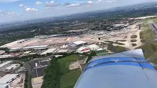Flight over Manchester airport during COVID-19. Parked planes (after lockdown eased) sit waiting.