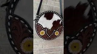What's more unique than a round purse? Stand out with the Flax Blossom Round Bag from Myra