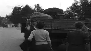 A small group of German refugees walk with their belongings along a country road ...HD Stock Footage