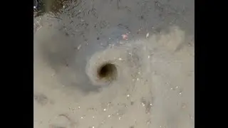 Big whirlpool after clearing a blocked drain. Heavy rain flooded the road until unblocked.