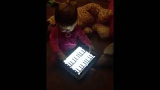 Evie playing piano on ipad