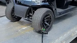 Another method strapping securing a golf cart to a trailer for transport