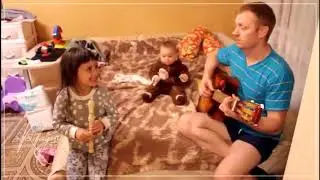 Very cute family playing music with guitar and flute - baby, little girl and dad