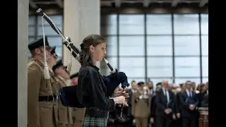 Bagpiper plays at Queen’s Memorial Lloyds of London. Loch Lomond. Piper Millie