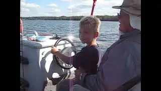 Zach driving the pontoon boat on Chief Lake, WI with great-grandpa Bob (2008)
