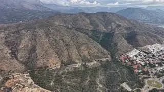 Housing clusters on arid slopes, Real estate agent examining property lots in hilly community