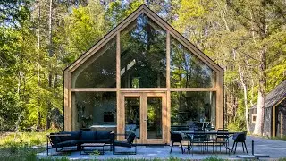 This prefab modular home includes an open floor plan + arched ceiling with curved pinewood walls!