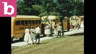 Children load school bus 1950s