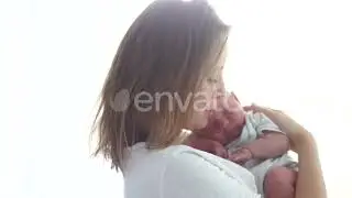 Mature Woman Hugging Her Newborn Baby. Mother and Child. IVF. Surrogacy. Baby From a Test Tube