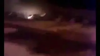 Libya- night time war zone Capitol City on fire tons of gunfire in the background