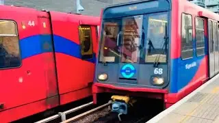 Two DLR trains arriving at Royal Victoria station 
