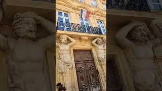 A pair of statue humans lifting up the Balcony windows Aix-En-Provence South France Europe, 8/5/2025