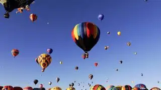 Video of colorful hot air balloons floating through the sky. 4k