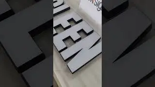 This sign features 3D laser-cut acrylic letters with integrated LED lights that glows from the face.