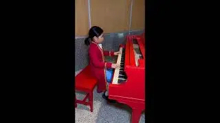 10 year old kid dressed as Mozart Playing Dr Dre on a baby grand piano