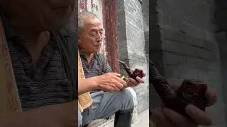 Elder preparing traditional smoking pipe