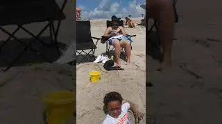 Funny kid stuck in sand beach.