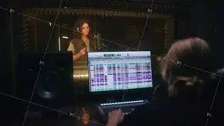 Female sound engineer works with singer in studio