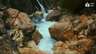 Soothing mountain stream flow through the rocks. Turquose water. Nature sounds.