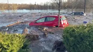 Cars are seen floating in flood water after strong storm hits northeastern U.S.