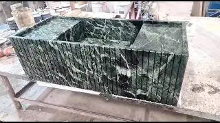 Bathroom sink in Verde Alpi marble.