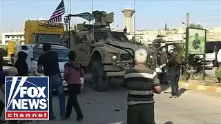 Kurdish protesters throw food, rocks at retreating US military