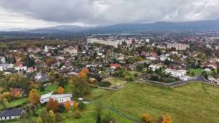 landscape overview visuals, town outskirts with nature, scenic drone shot of rural town boundaries