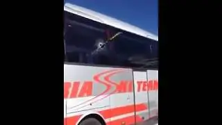 Skier gets ski through bus window