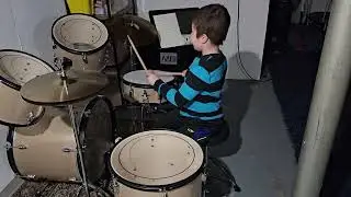 JJ playing with his new drum kit