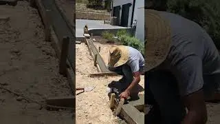 Pouring concrete curbing for paver walkway #austintexas #construction #concrete #landscape #pavers