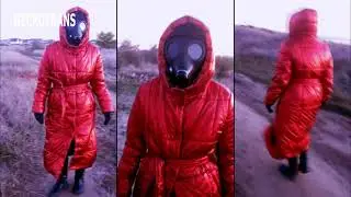 Out-of-town walk in a leather suit, mask and red shiny long down-padded coat with a hood and a belt.