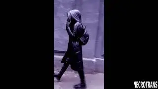 Walking in shiny black leather suits and gas masks. Leather jumpsuit, leather down jacket with hood