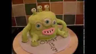 Green six eyed monster birthday cake made with fondant.